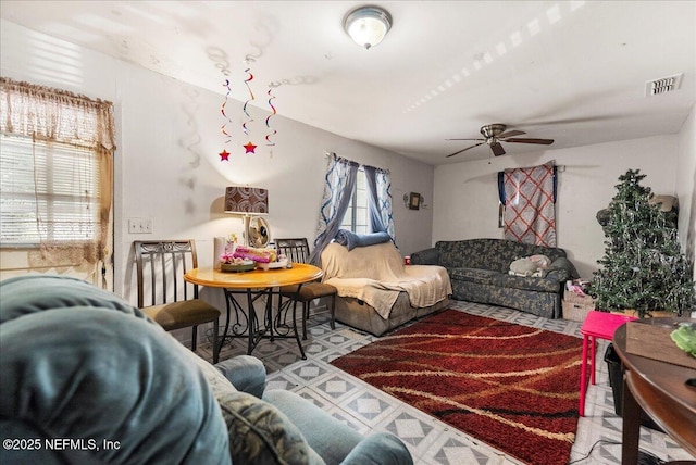 living area featuring visible vents and ceiling fan