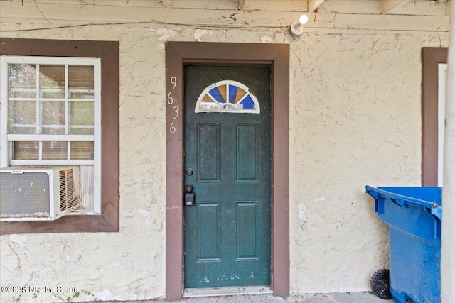 doorway to property with stucco siding