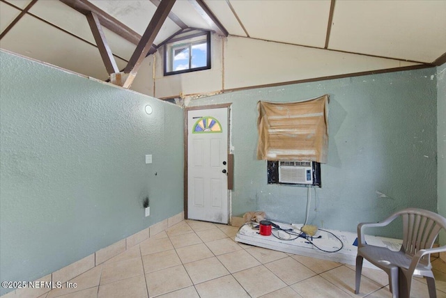 entryway featuring light tile patterned floors, cooling unit, and vaulted ceiling with beams