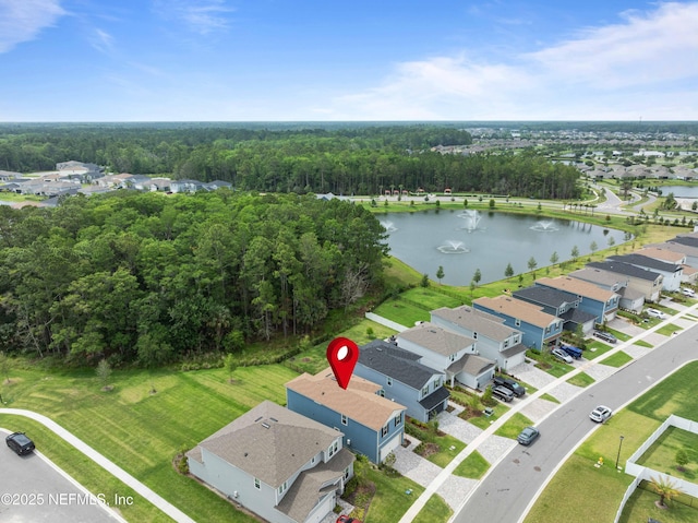 birds eye view of property with a residential view, a water view, and a wooded view