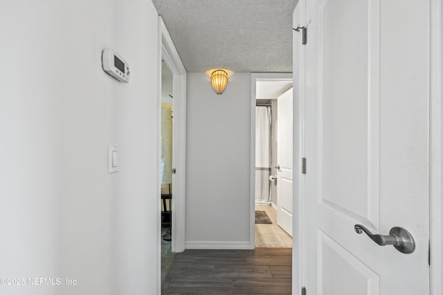 756 Aquatic Dr, Atlantic Beach, FL 32233 - hallway featuring baseboards, a textured ceiling, and wood finished floors