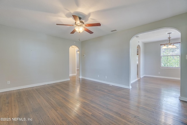 4059 College St, Jacksonville, FL 32205 - unfurnished room with visible vents, arched walkways, ceiling fan with notable chandelier, and wood finished floors