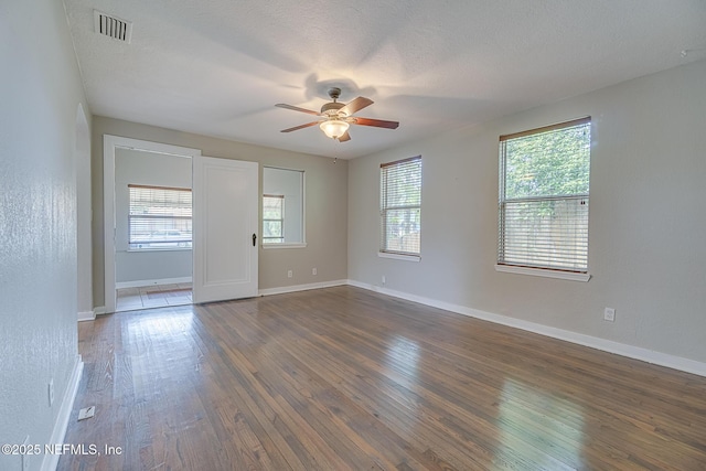 4059 College St, Jacksonville, FL 32205 - spare room featuring baseboards, ceiling fan, dark wood finished floors, and visible vents