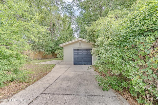 4059 College St, Jacksonville, FL 32205 - garage featuring concrete driveway and fence