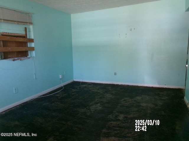 carpeted empty room with baseboards