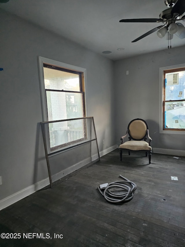 unfurnished room featuring plenty of natural light, ceiling fan, baseboards, and hardwood / wood-style flooring