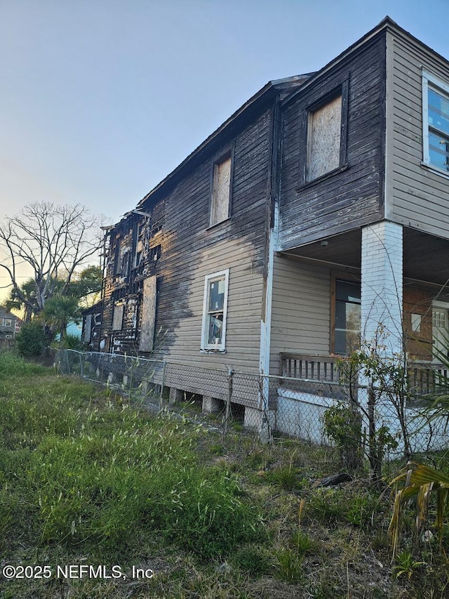 view of side of property featuring fence