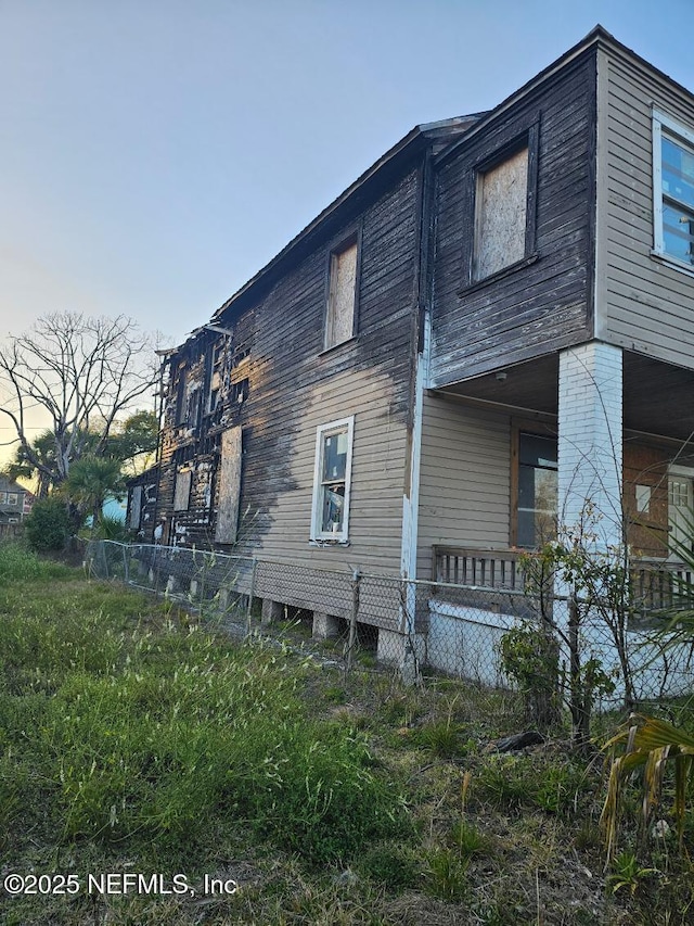 view of side of home with fence