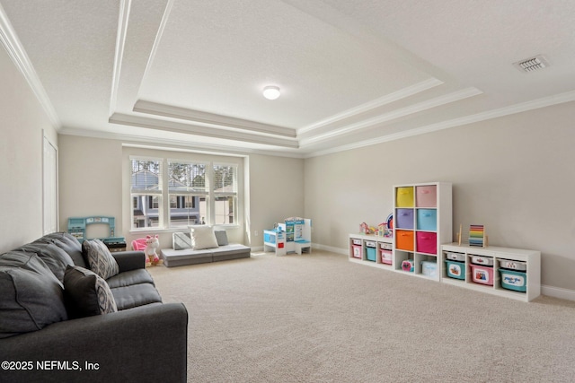 rec room featuring visible vents, crown molding, baseboards, a tray ceiling, and carpet floors