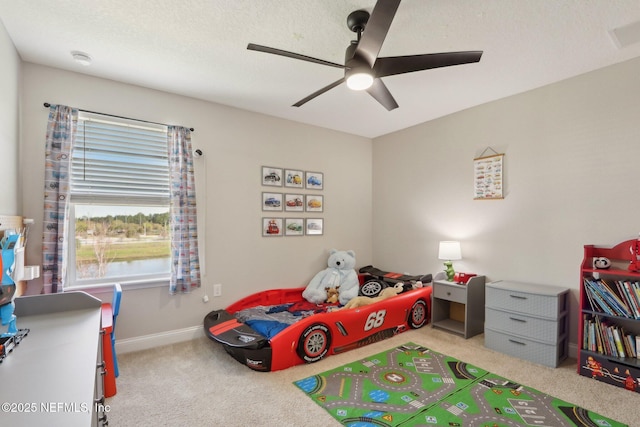 bedroom with a textured ceiling, a ceiling fan, baseboards, and carpet floors