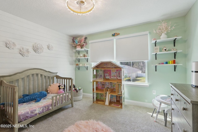 carpeted bedroom with baseboards and a textured ceiling