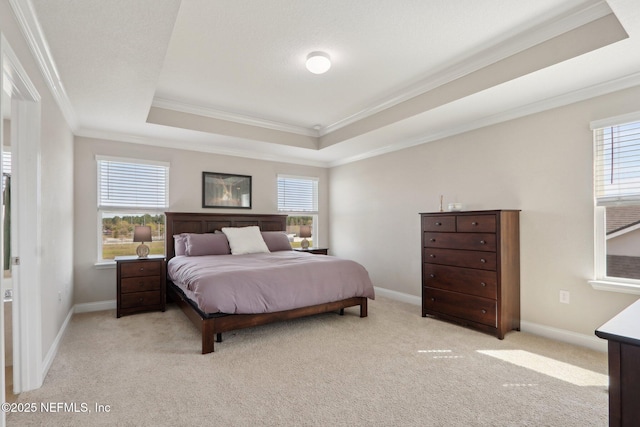 carpeted bedroom with multiple windows, a raised ceiling, baseboards, and crown molding