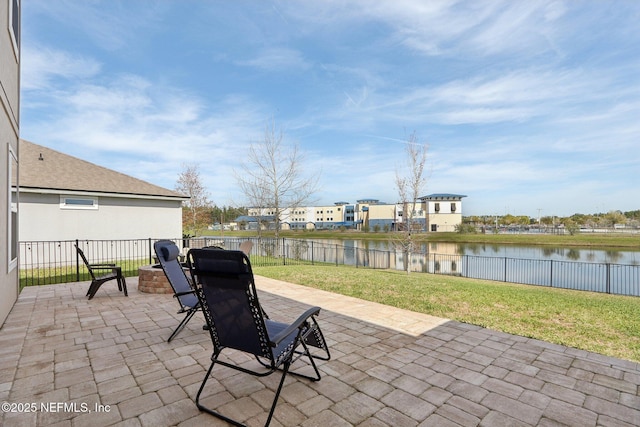 view of patio / terrace featuring a water view and a fenced backyard