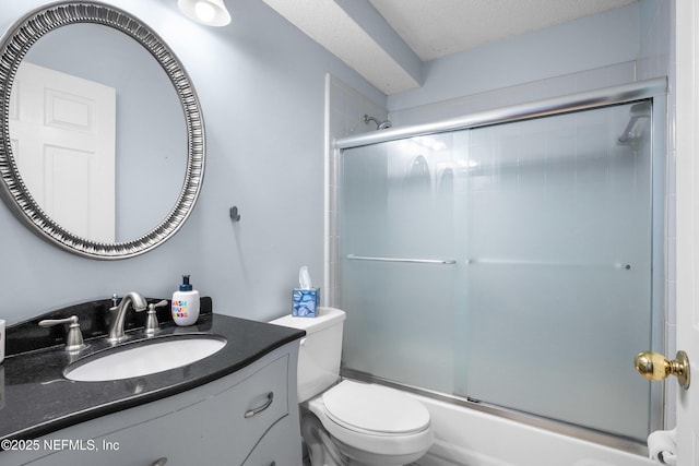 bathroom featuring enclosed tub / shower combo, toilet, a textured ceiling, and vanity