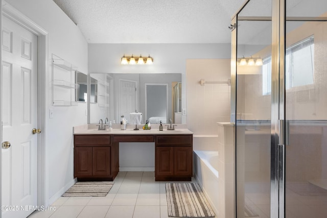 full bathroom featuring double vanity, a stall shower, a sink, a textured ceiling, and a bath