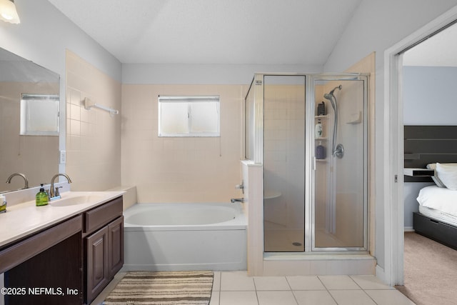 full bath with a shower stall, tile patterned floors, connected bathroom, a bath, and vanity