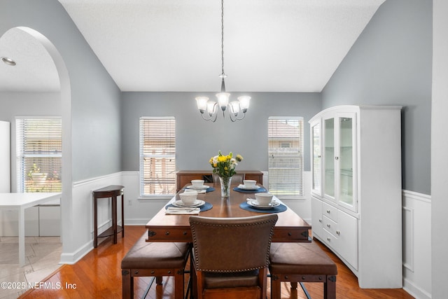 dining room with plenty of natural light, arched walkways, and a chandelier