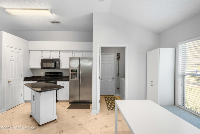 kitchen with electric range, visible vents, stainless steel refrigerator with ice dispenser, black microwave, and vaulted ceiling