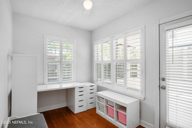 home office with wood finished floors and a textured ceiling