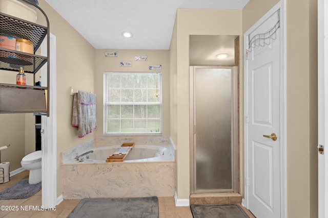 bathroom with a garden tub, baseboards, a stall shower, tile patterned floors, and toilet