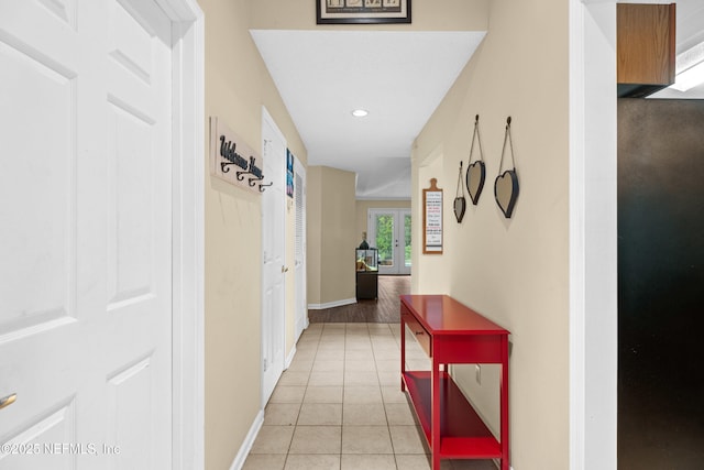 corridor featuring light tile patterned flooring, recessed lighting, and baseboards