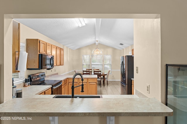 kitchen with black electric range oven, a sink, freestanding refrigerator, a peninsula, and lofted ceiling