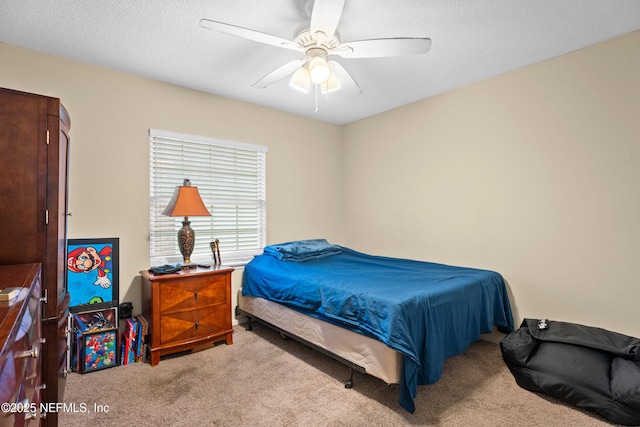 carpeted bedroom with a textured ceiling and ceiling fan