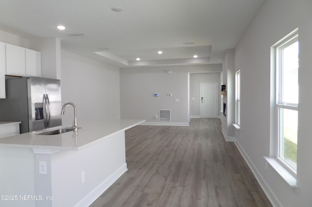 kitchen featuring a sink, recessed lighting, white cabinets, and stainless steel refrigerator with ice dispenser