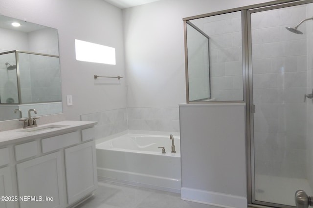 bathroom with a bath, a shower stall, and vanity