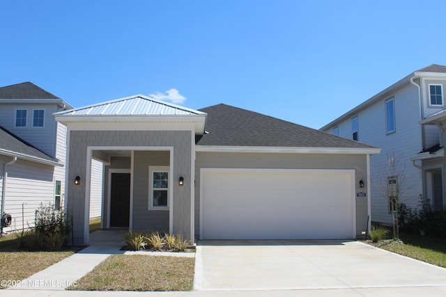 view of front of house featuring a garage, driveway, and roof with shingles