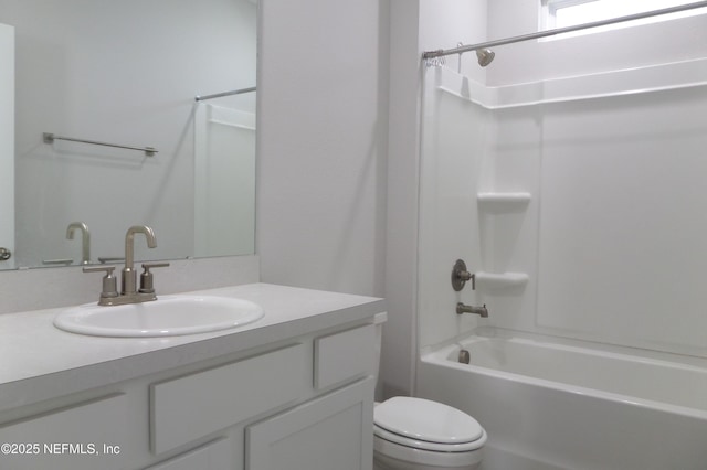 bathroom featuring vanity, bathing tub / shower combination, and toilet