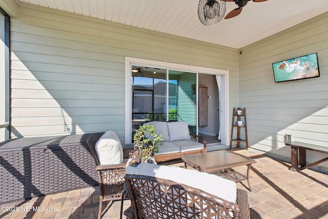 view of patio with an outdoor living space and a ceiling fan