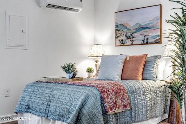 bedroom with electric panel and a wall mounted AC