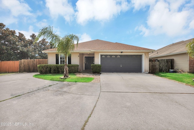 single story home featuring stucco siding, concrete driveway, a garage, and fence