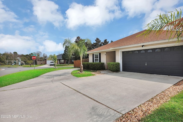 ranch-style home featuring stucco siding, an attached garage, concrete driveway, and a shingled roof