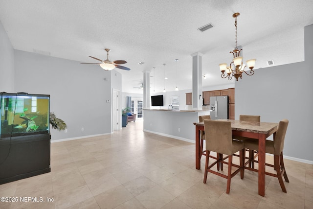 dining area with visible vents, baseboards, a textured ceiling, and ceiling fan with notable chandelier