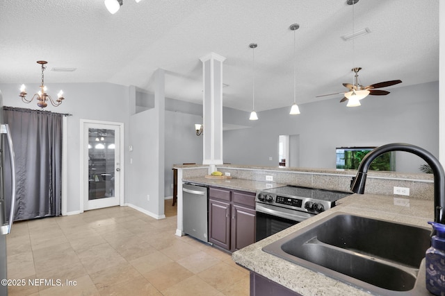 kitchen featuring pendant lighting, vaulted ceiling, appliances with stainless steel finishes, a textured ceiling, and a sink