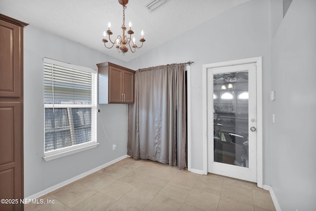 unfurnished dining area featuring baseboards, visible vents, lofted ceiling, a textured ceiling, and a chandelier