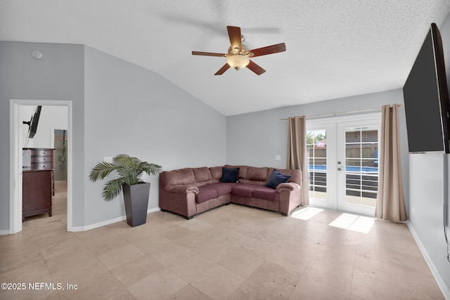 living room with baseboards, ceiling fan, vaulted ceiling, french doors, and a textured ceiling