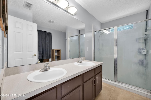 full bath with a sink, visible vents, and a shower stall