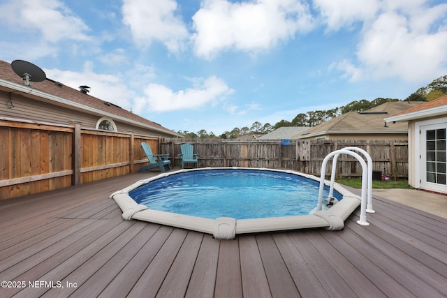 view of pool with a deck and a fenced backyard