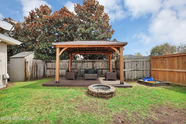 view of yard featuring a gazebo, a fire pit, and a fenced backyard