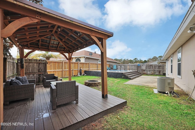 wooden terrace with a yard, a fenced backyard, a gazebo, a fire pit, and central air condition unit