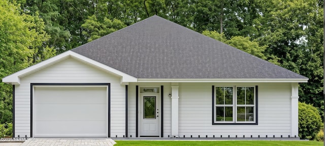 single story home with a garage, a front yard, driveway, and a shingled roof