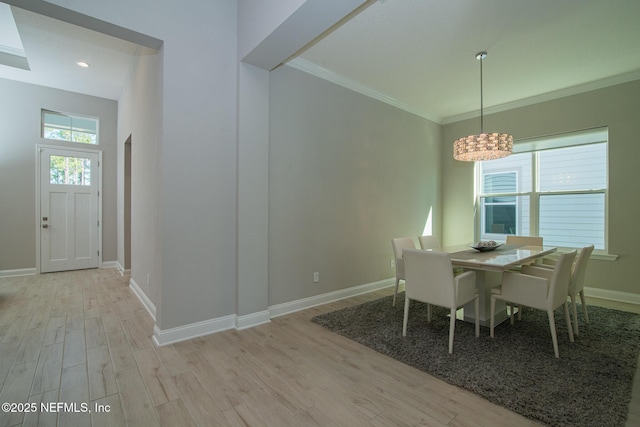 dining area with crown molding, baseboards, and wood finished floors