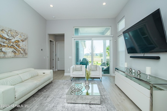 living area with recessed lighting, baseboards, and light wood finished floors