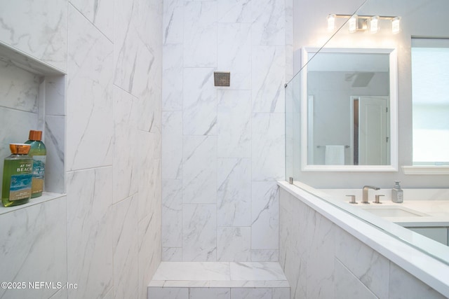 bathroom featuring vanity and a tile shower