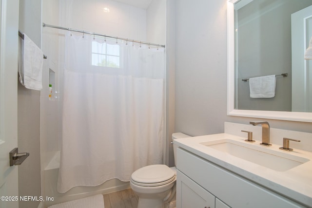 bathroom featuring shower / tub combo, toilet, and vanity