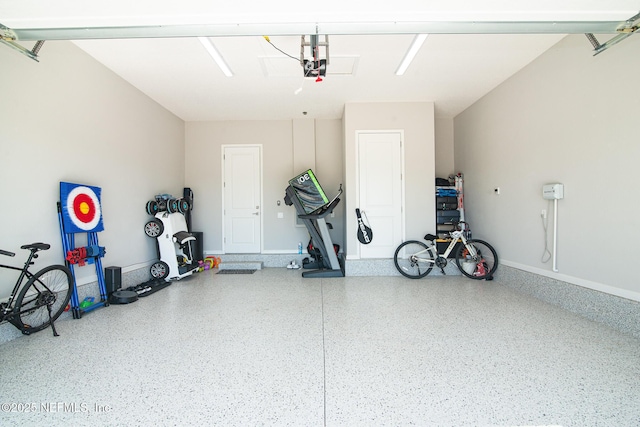 garage with baseboards and a garage door opener