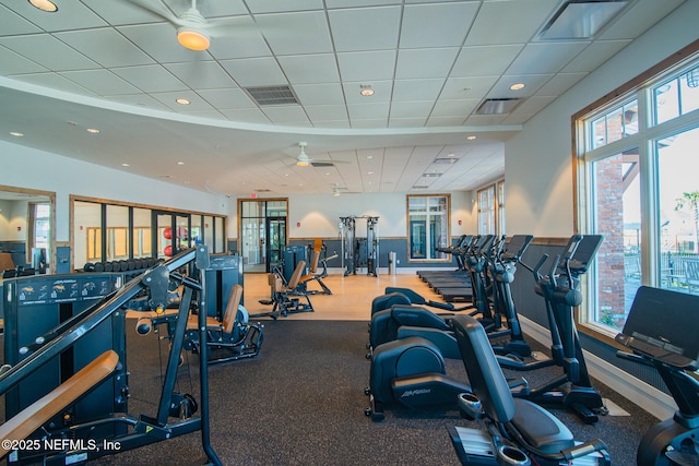 exercise room featuring recessed lighting, a paneled ceiling, visible vents, and baseboards